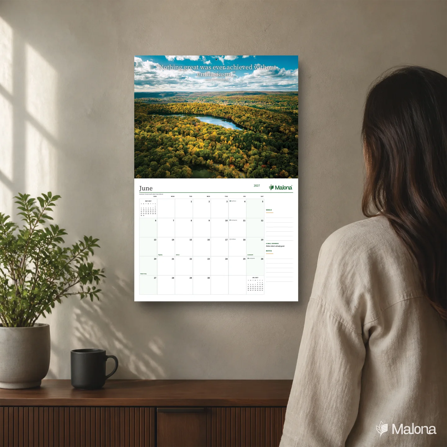 Lifestyle mockup of the 2027 Inspirational Quotes Classic calendar on a wall, showing a nature photograph, monthly quote, June grid, Goals and Notes