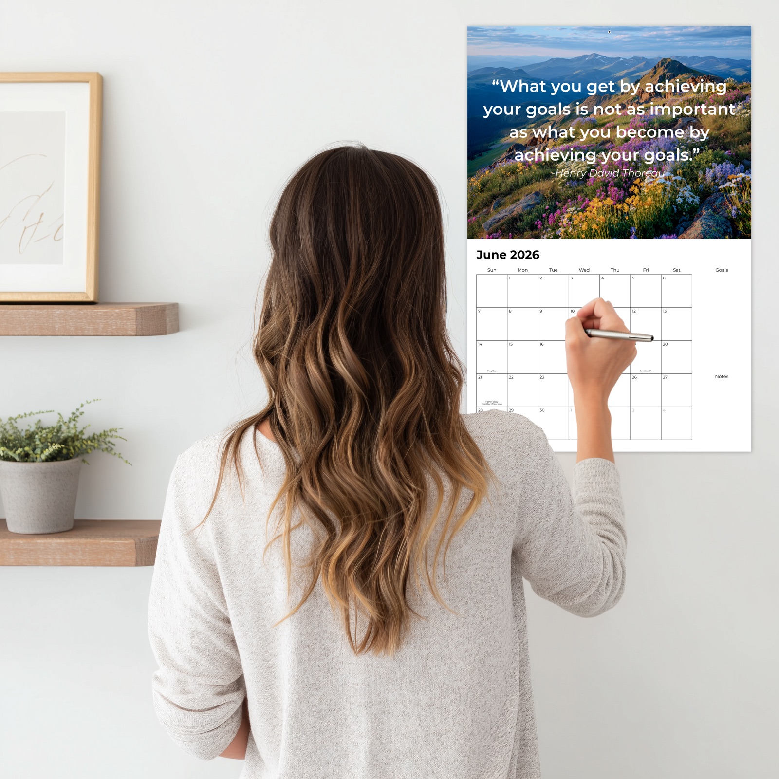 Malona Inspirational Quotes Calendar shown open on a wall with a large monthly writing grid.